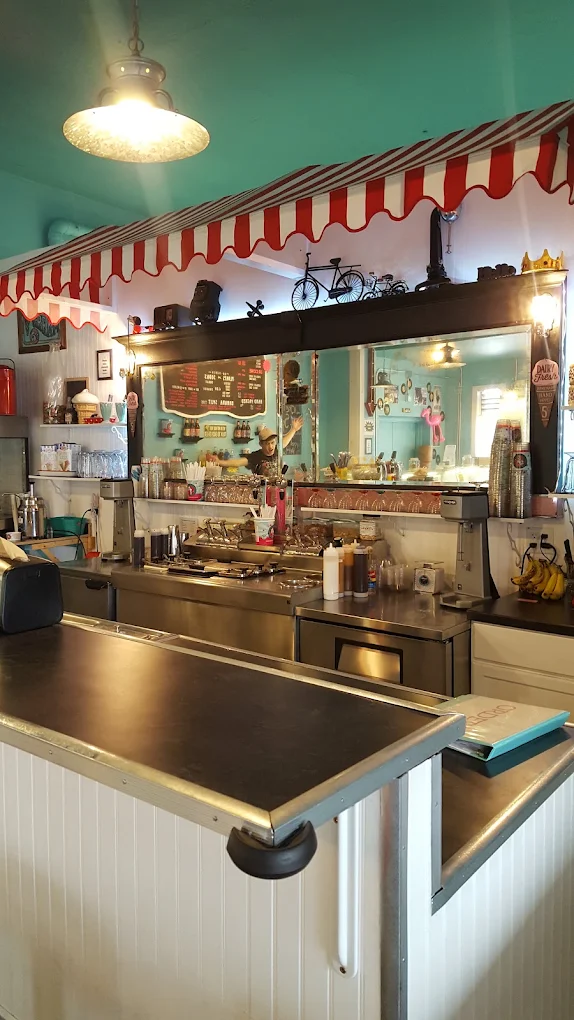 Interior counter of Double Dip Ice Cream Shop featuring an old-fashioned ice cream serving area with menu boards and soda fountain decor.